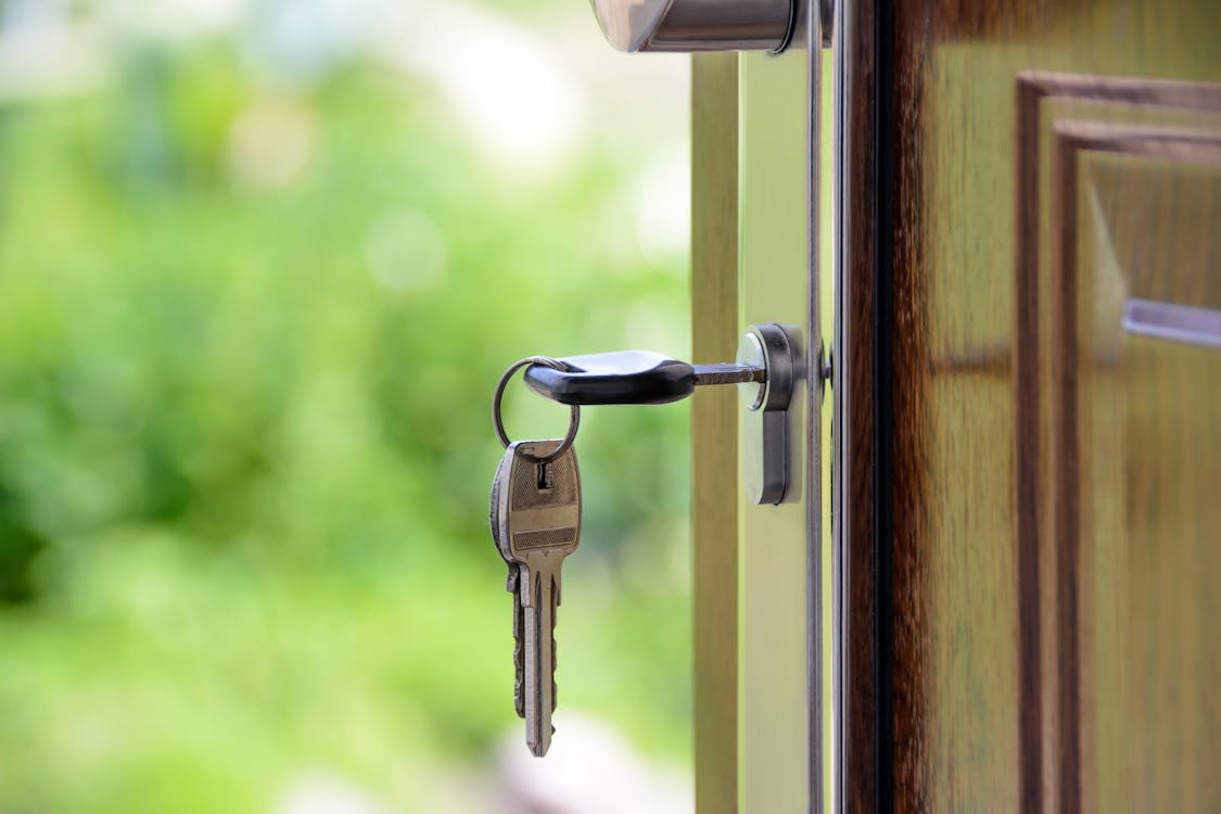  A closeup of a key in a door’s keyhole