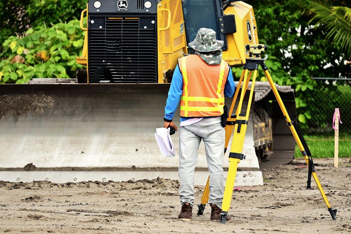 Surveyor measuring land for construction 