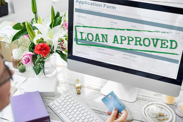 “Loan Approved” stamped on a computer screen