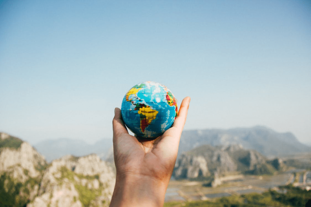 A person holding a globe in their hands.