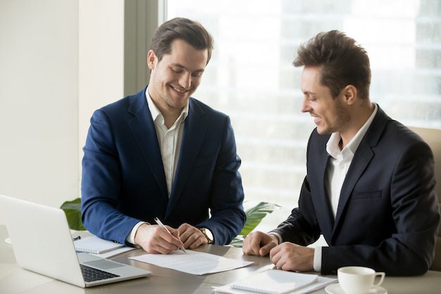 person signing documents with a single-family rental loan expert