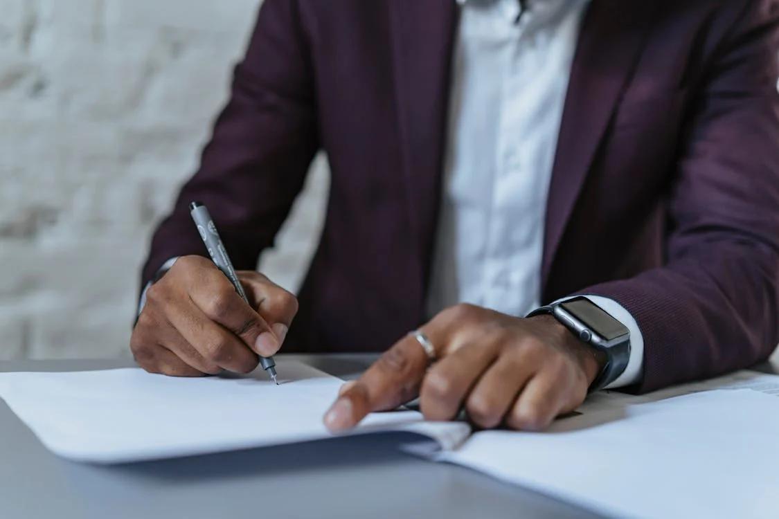 A man filling out paperwork 