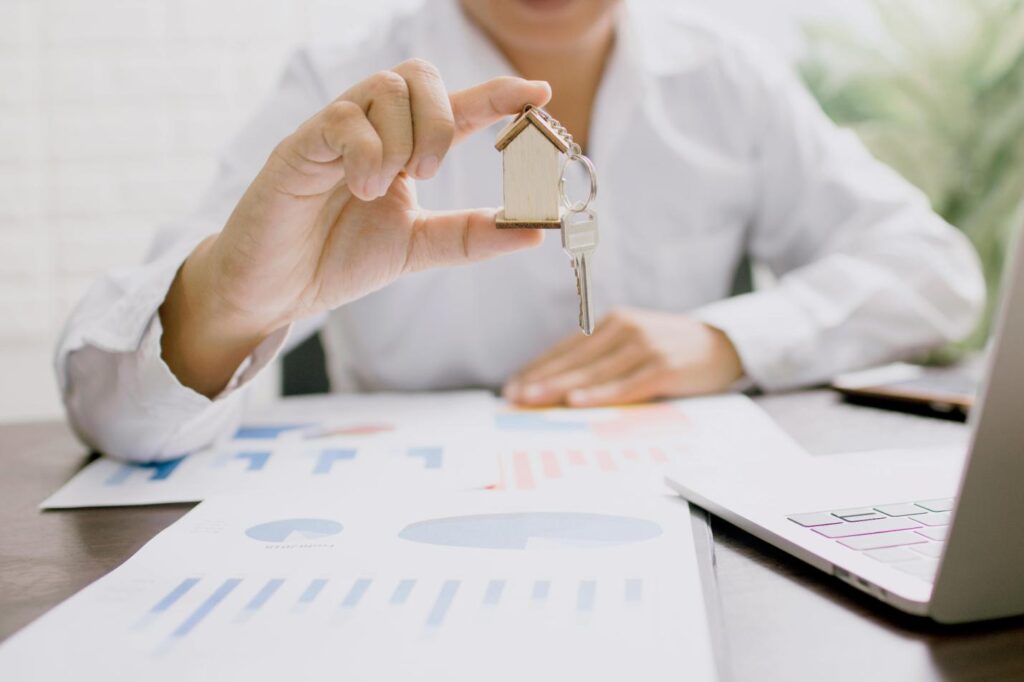 A key with a miniature house keychain