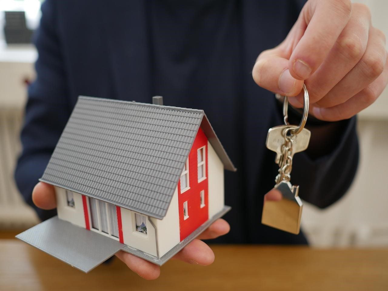 an individual handing over the keys of a home