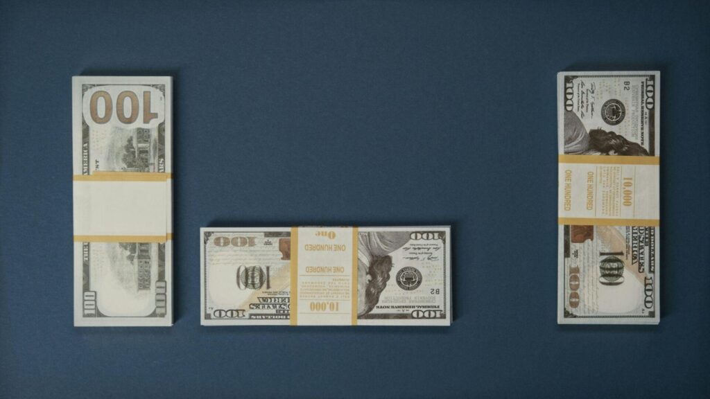 Hundred-dollar bills placed against a blue background