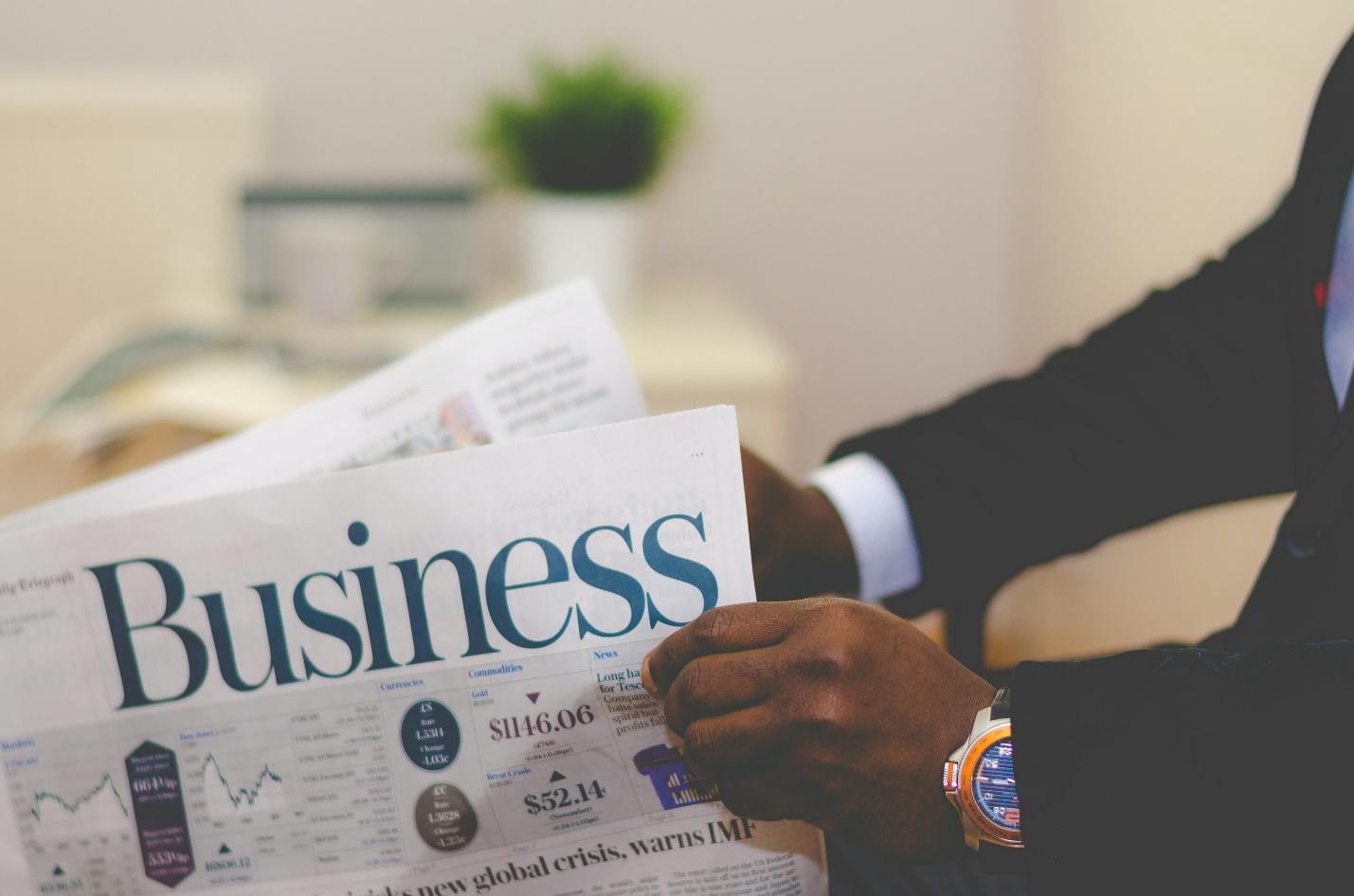 A person holding a newspaper.