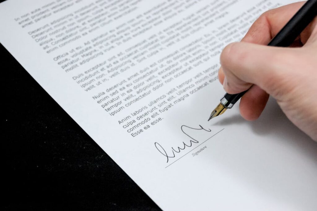 A person signing a paper.