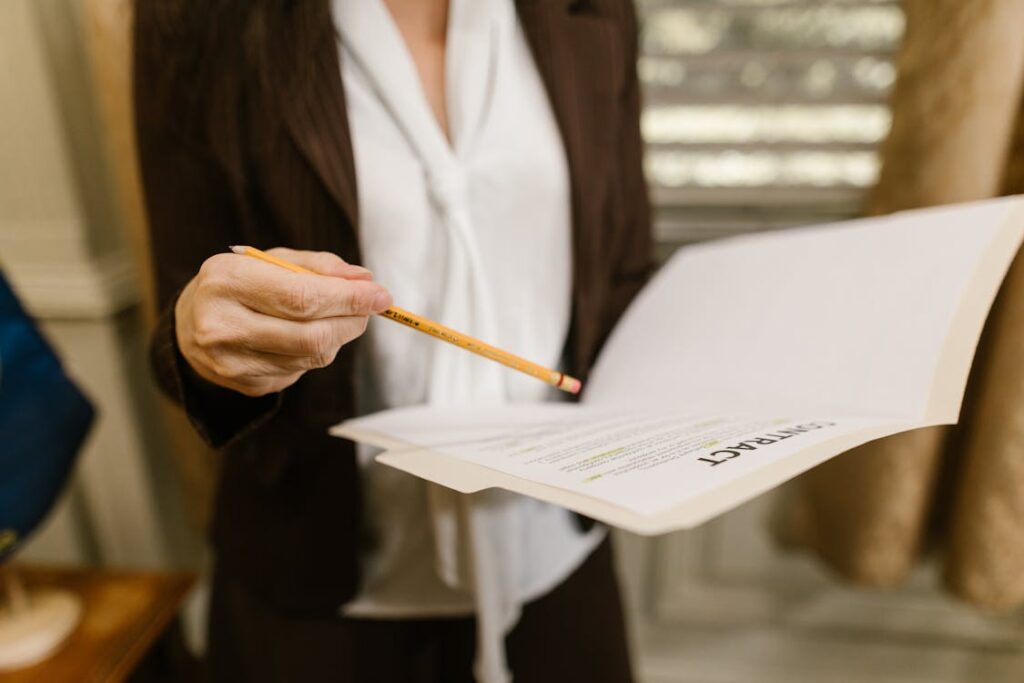 A person holding a pencil and a book.