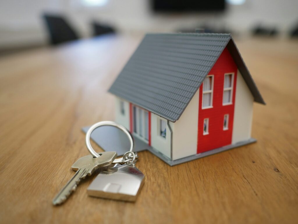 A large house with keys next to it.