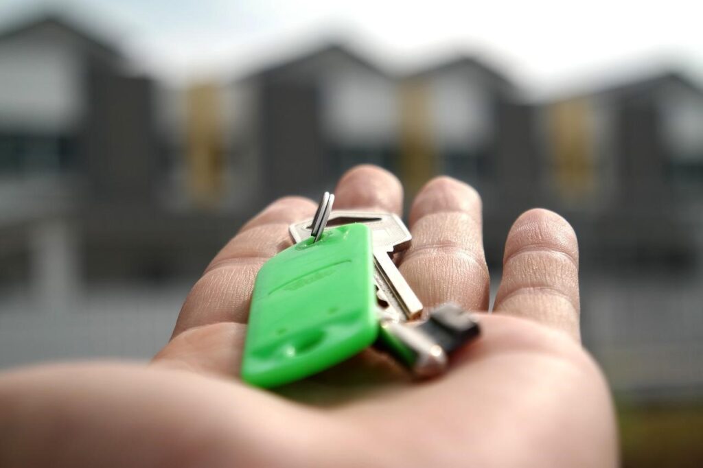 an individual holding the keys to a home