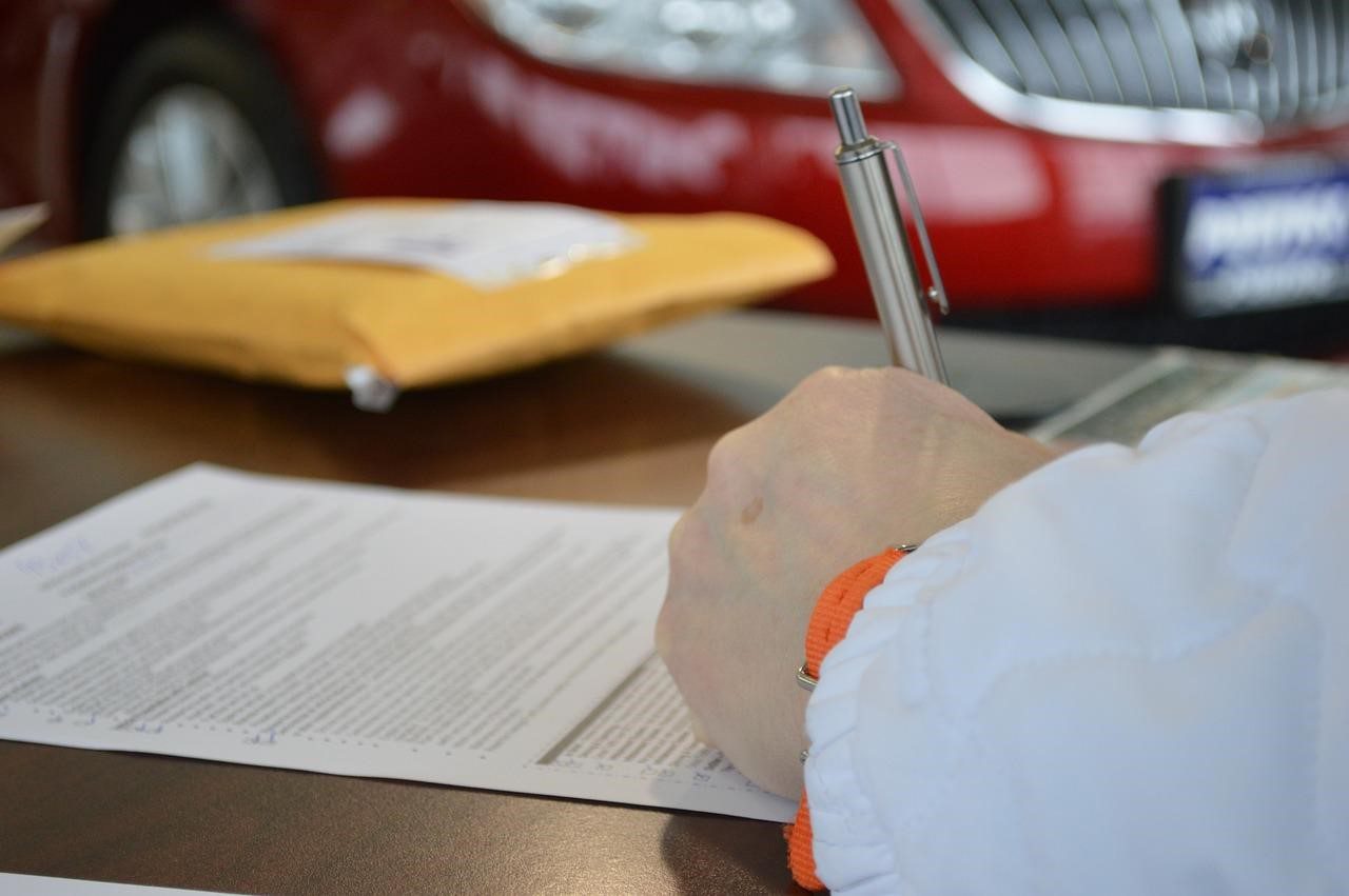 an individual signing a document 