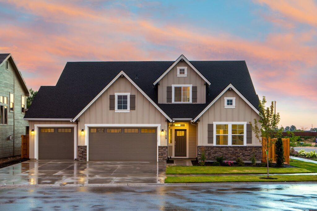 A brown and gray painted house in front of a road, representing a potential new construction project.