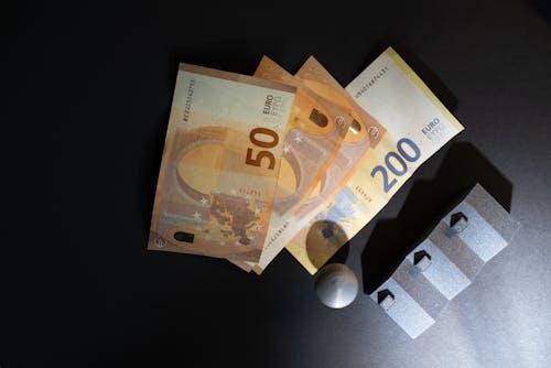 A stack of Euro banknotes representing financial resources and the role of hard money lenders in empowering real estate investors.