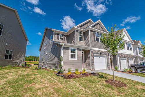 A well-maintained house under a clear blue sky, reflecting real estate success supported by hard money loans.