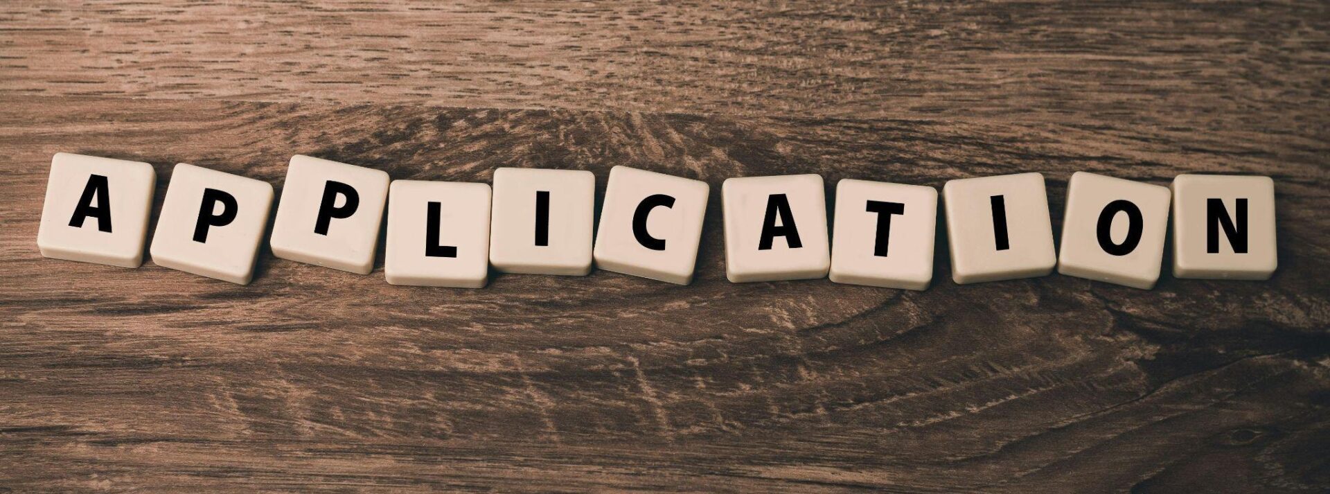 The word application is spelled out with letter cubes