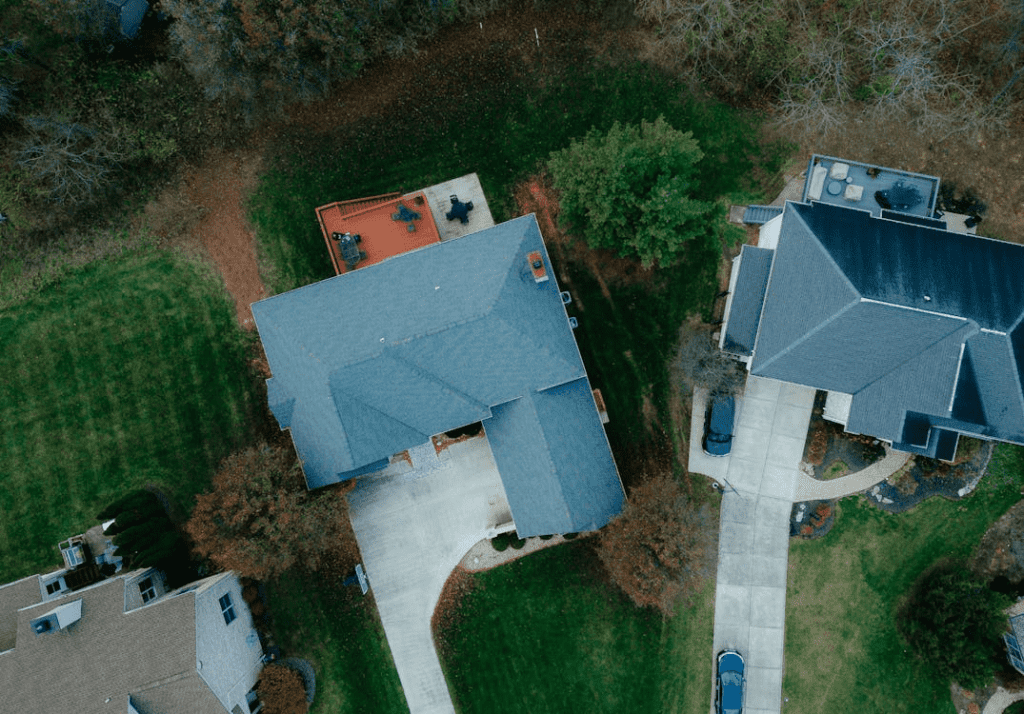 A bird's eye view of houses, showcasing sustainable real estate projects supported by development loans