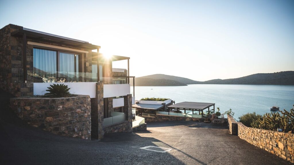 A brown concrete house by the sea, symbolizing waterfront property investment.