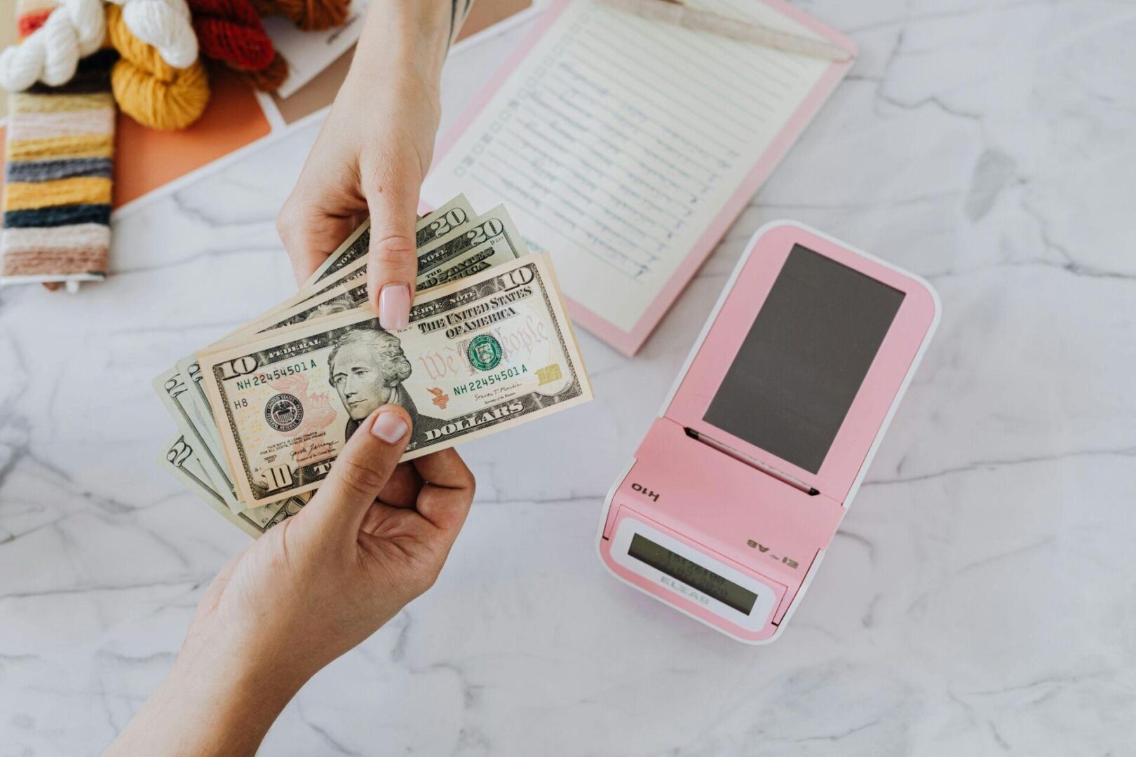  A person giving stacks of cash to another individual