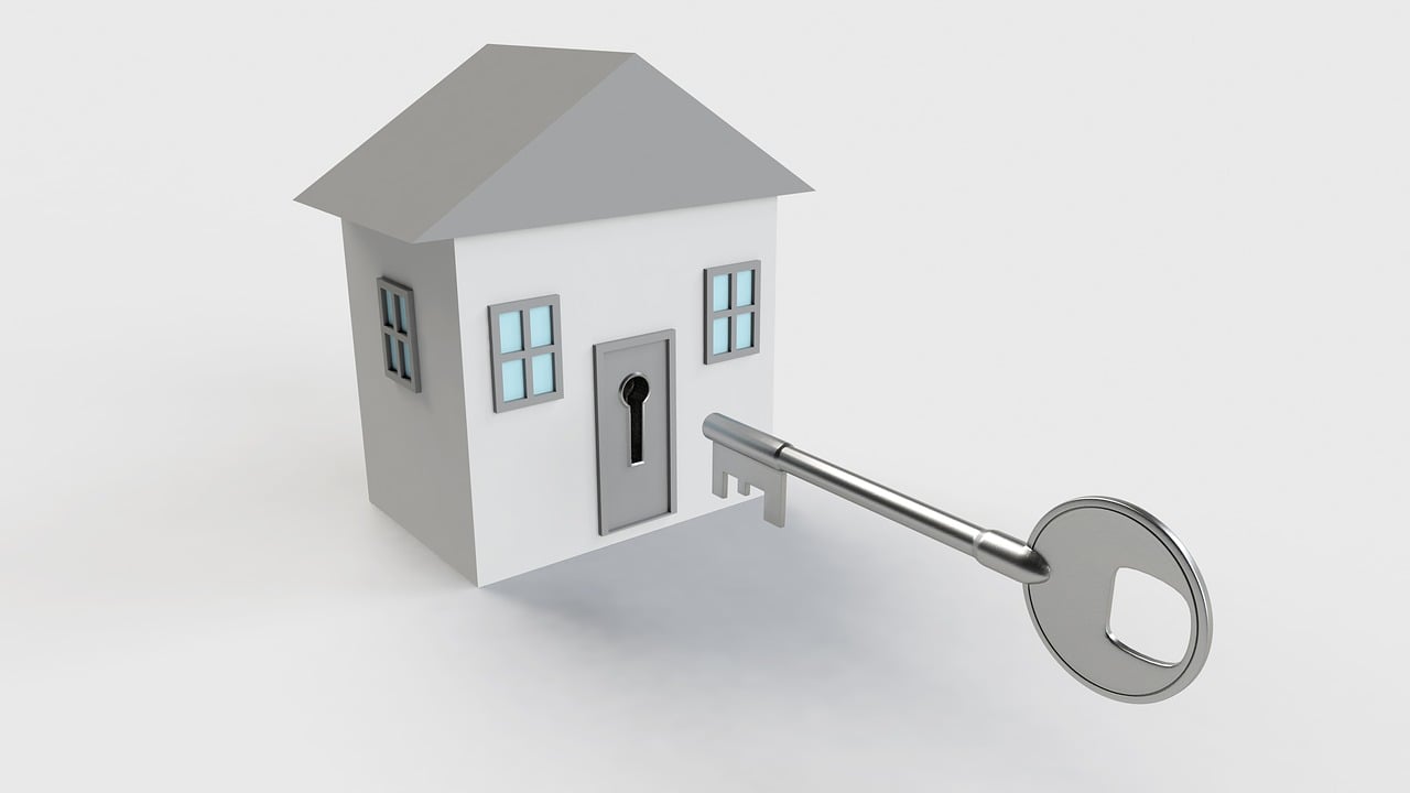 A small grey house with a large key