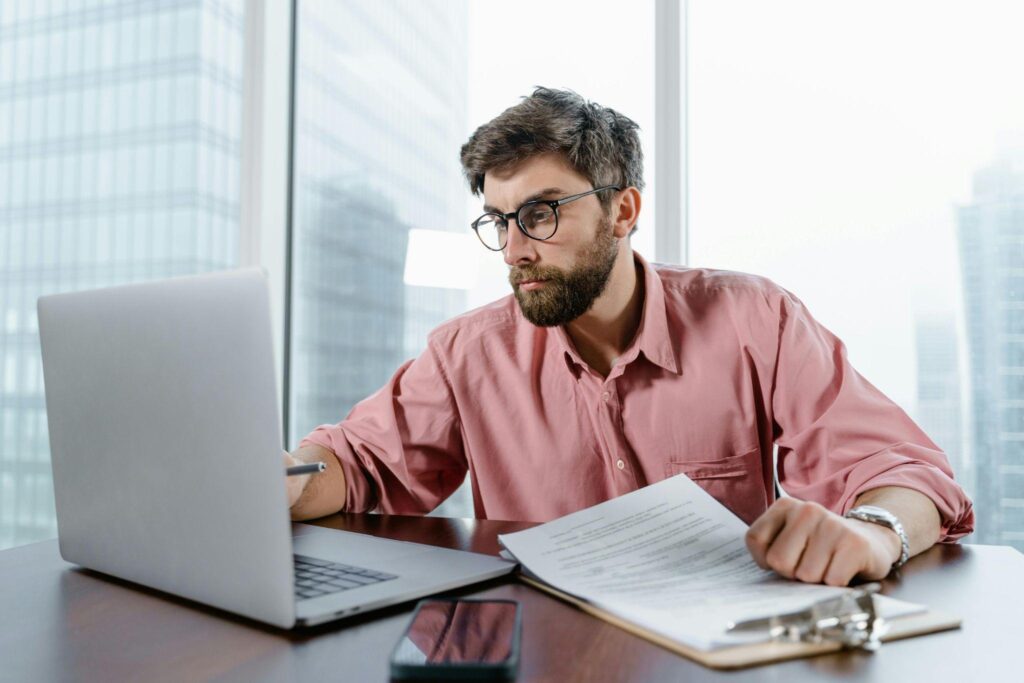 Investor analyzing market trends on a laptop, emphasizing data-driven private lending solutions.