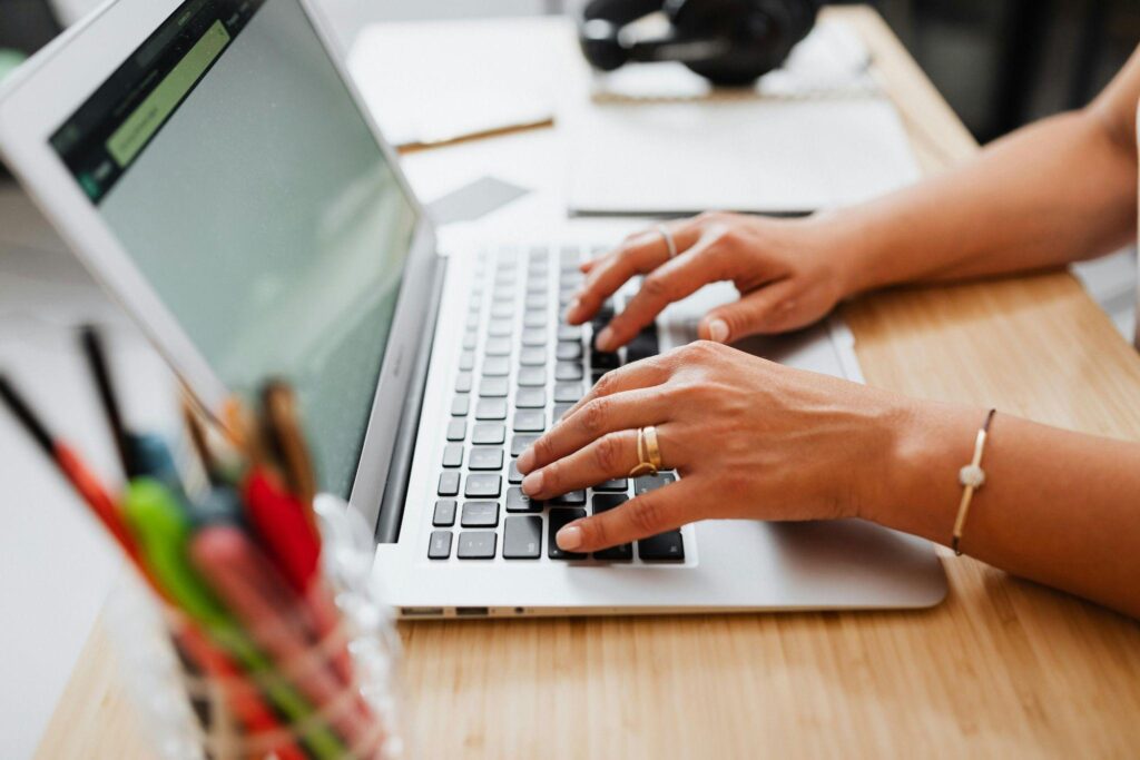 Woman filling loan application on a laptop.