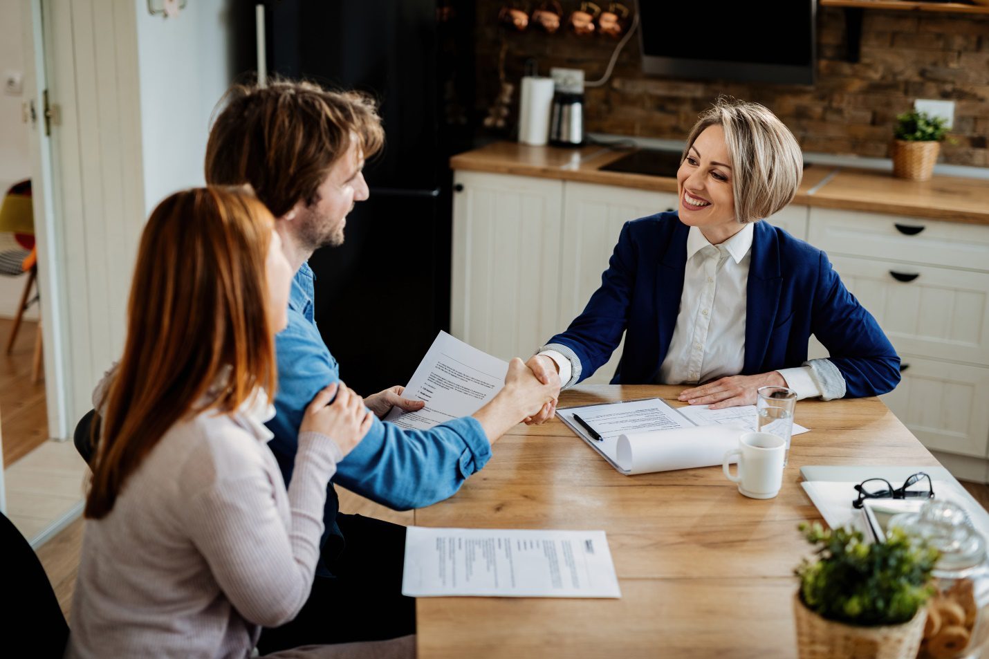 Happy Agent shaking hands with a client.