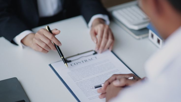 A man signing a contract