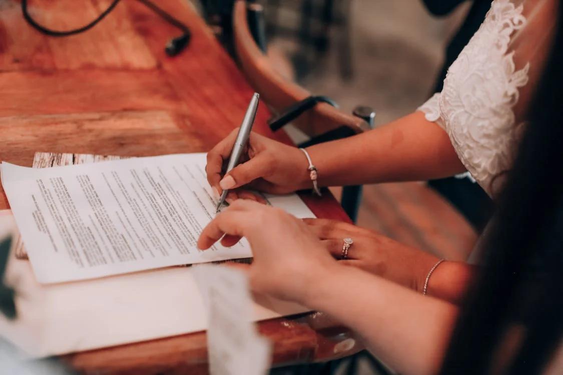 An image of a woman signing some papers