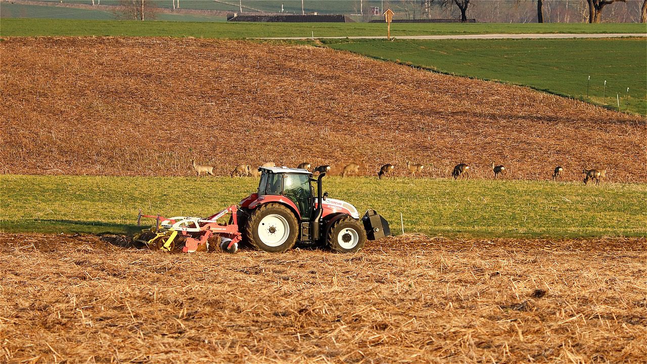 a tractor in the middle of an agricultural field