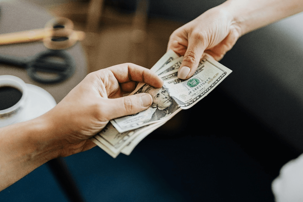 People exchanging dollar bills