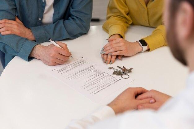 A real estate investor signing loan approval documents with a hard money lender