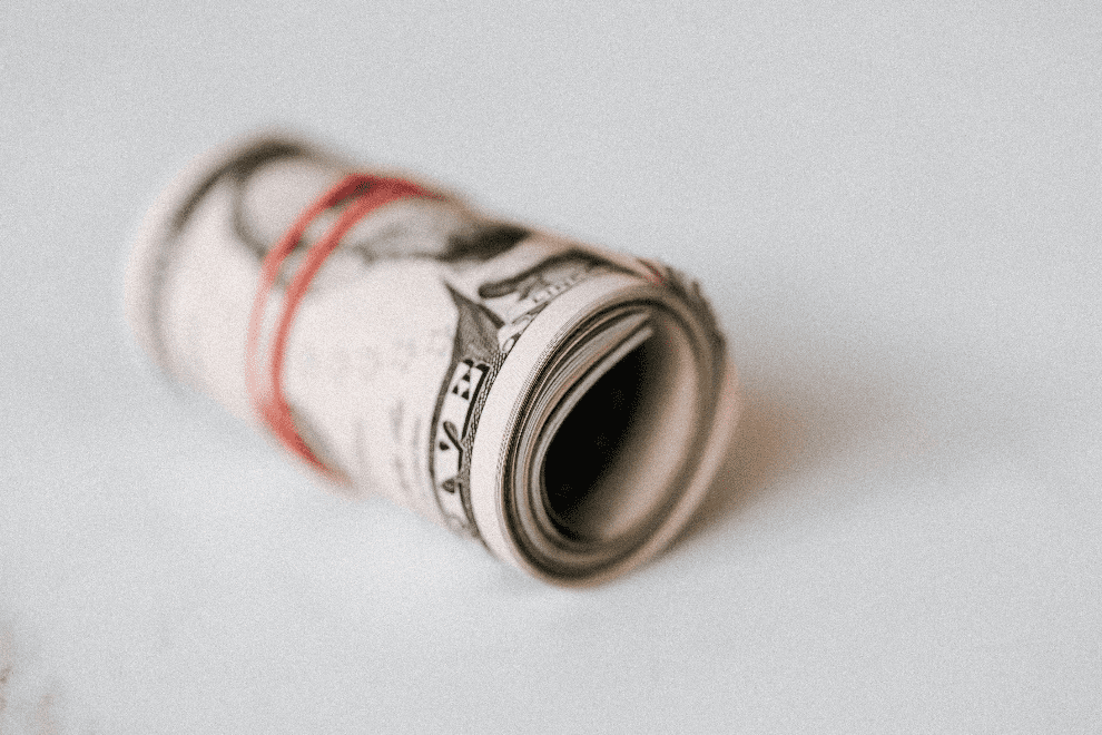 A rolled wad of dollar bills