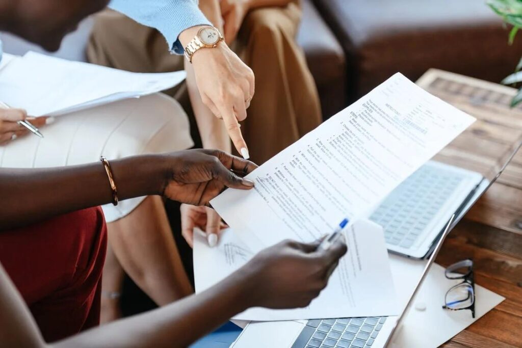 An image of a people holding documents