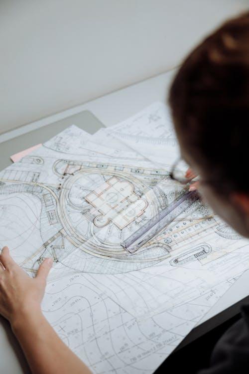 A construction site with blueprints and financial documents on a table