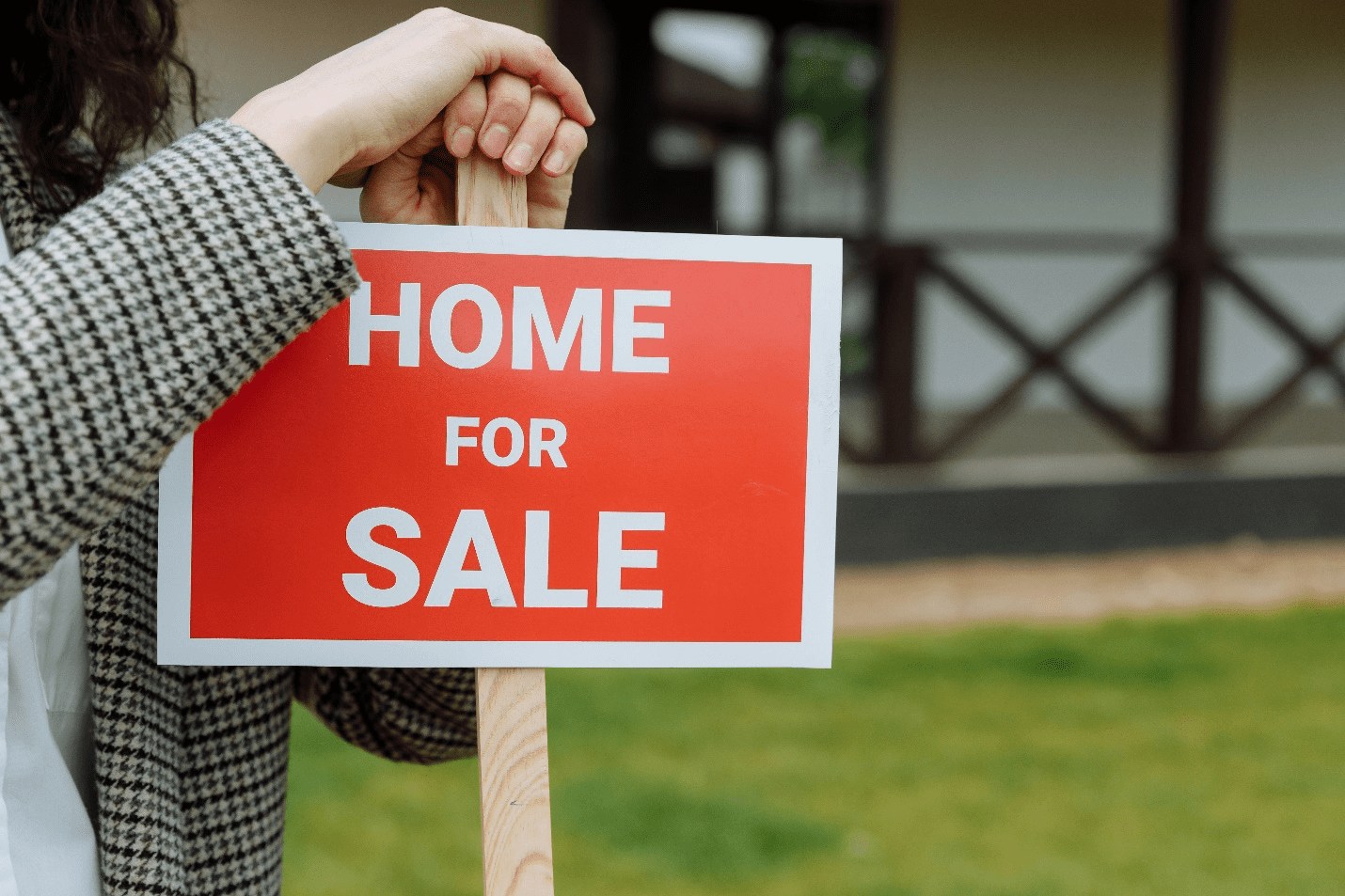 A picture of a person holding a signage post