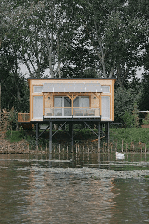 A modern home elevated on stilts with a flood-resistant foundation