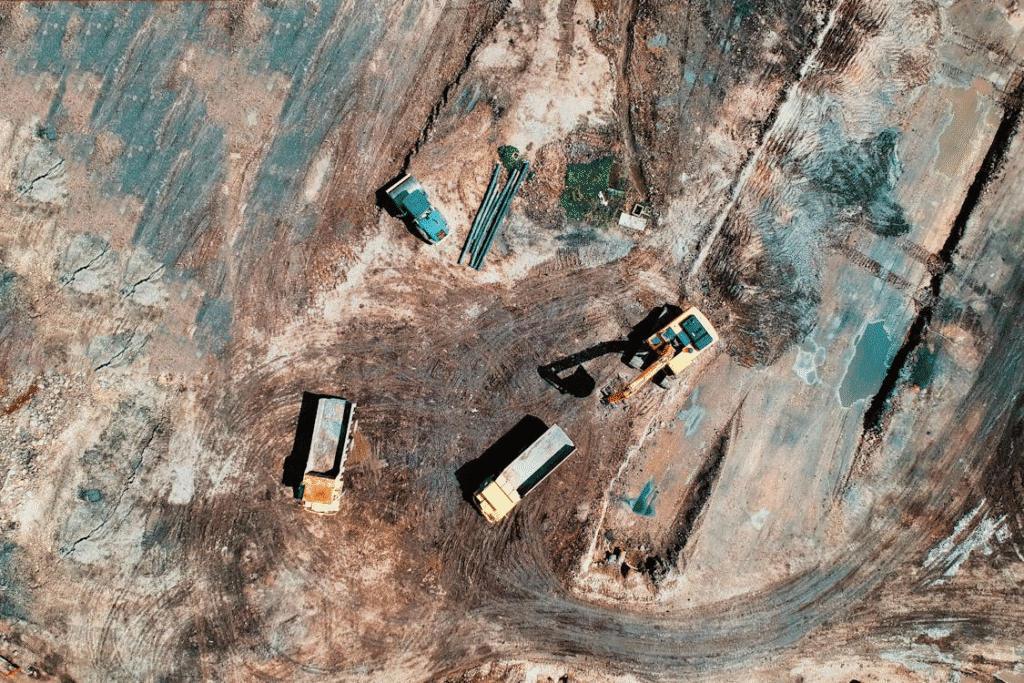 A construction site with cleared land and visible survey markers.