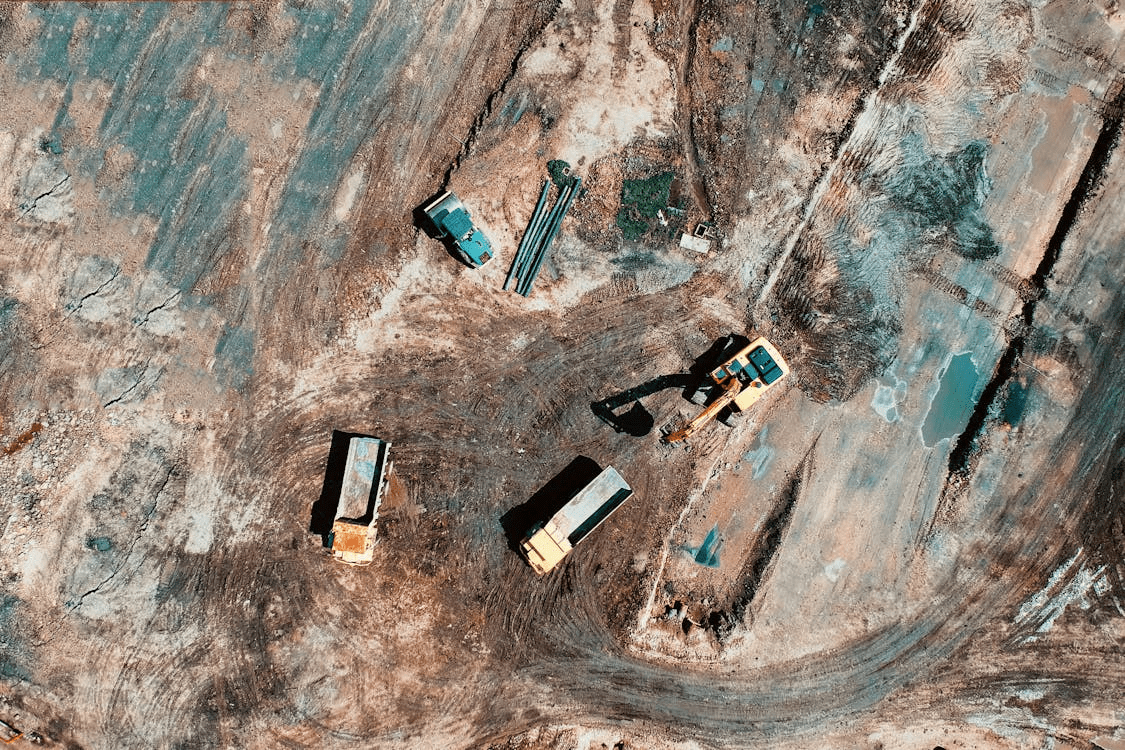 A construction site with cleared land and visible survey markers.