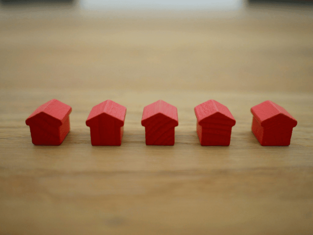  Mini red houses arranged in a row.