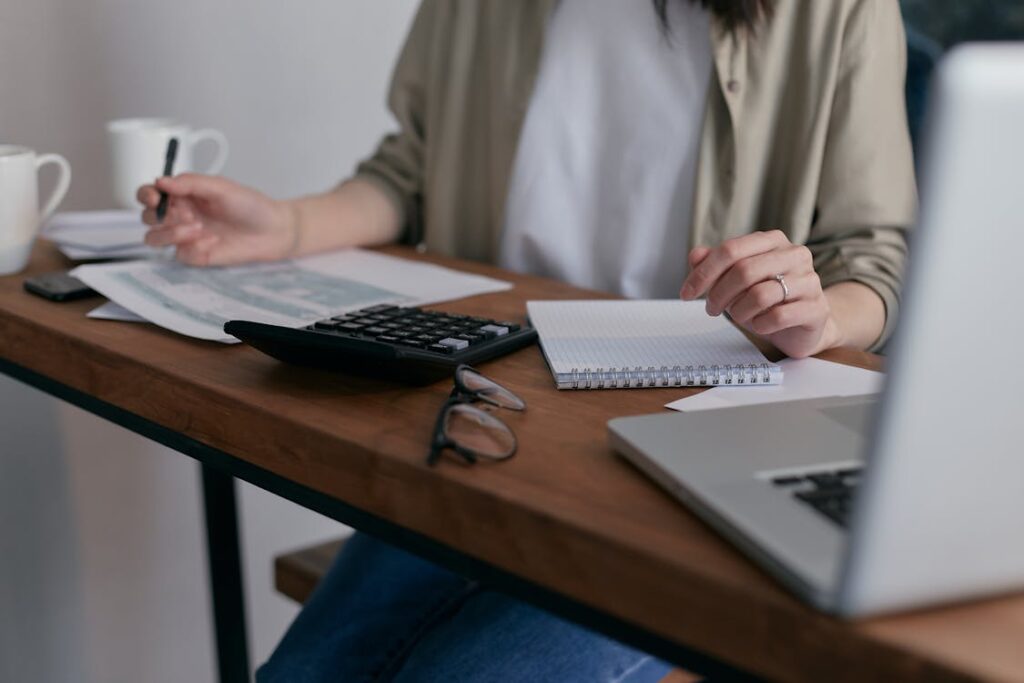 A person sitting on a desk and working.