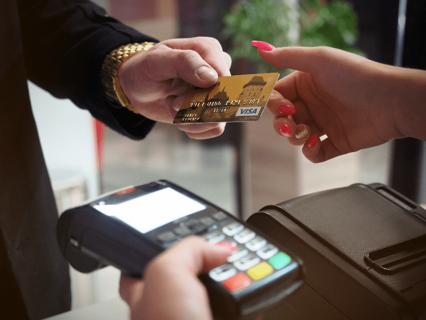 Person holding a black payment terminal