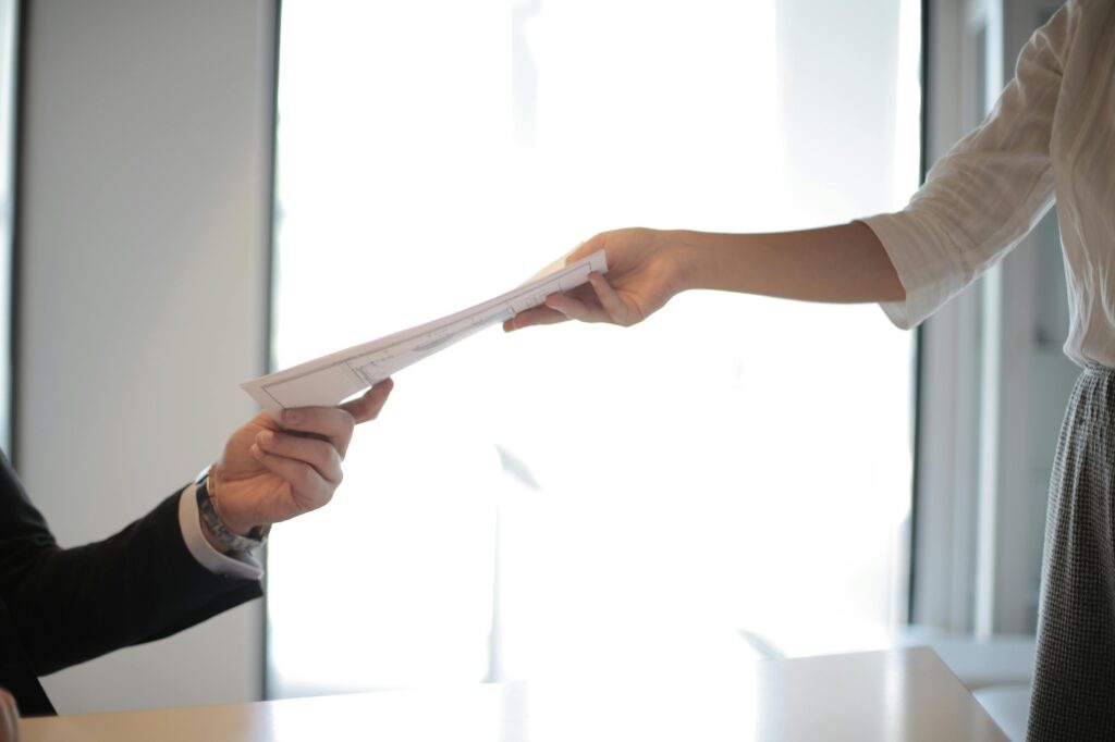 Money lender handing papers to a client 