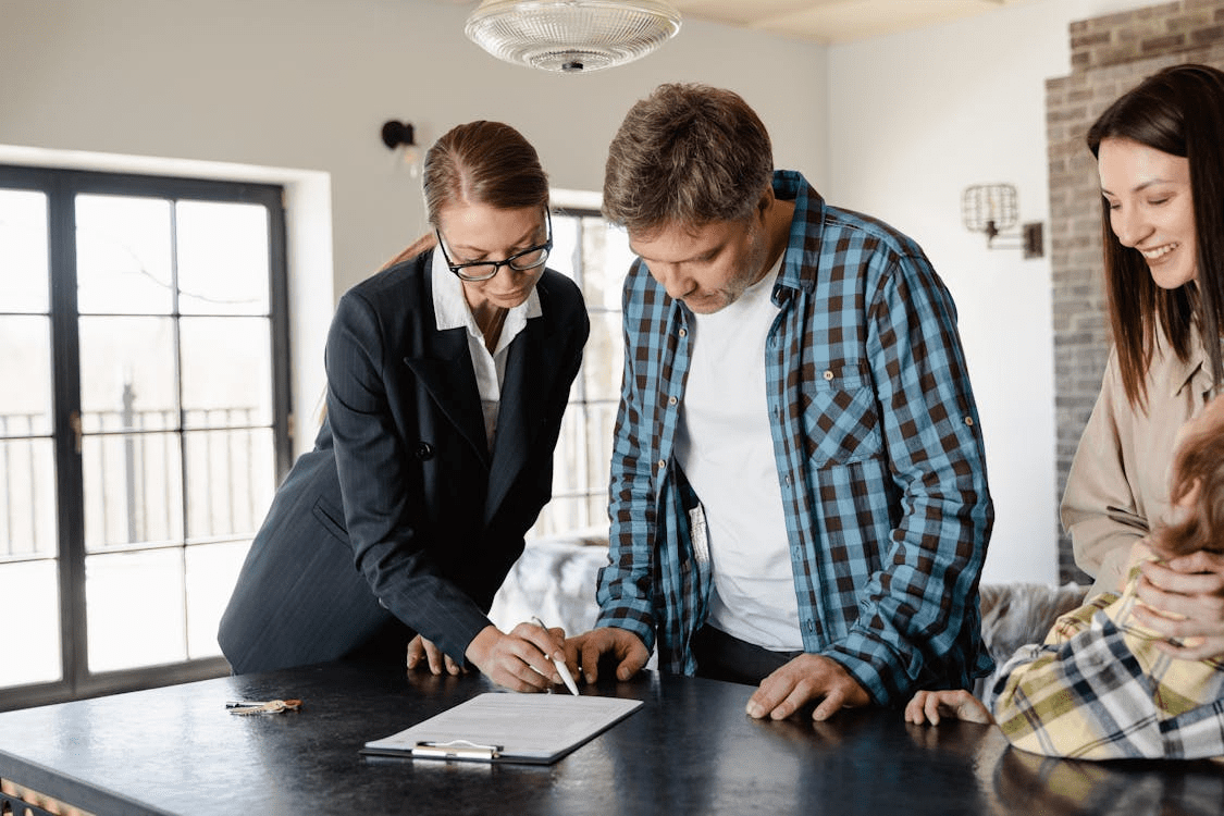 A group of real estate investors reviewing property documents together