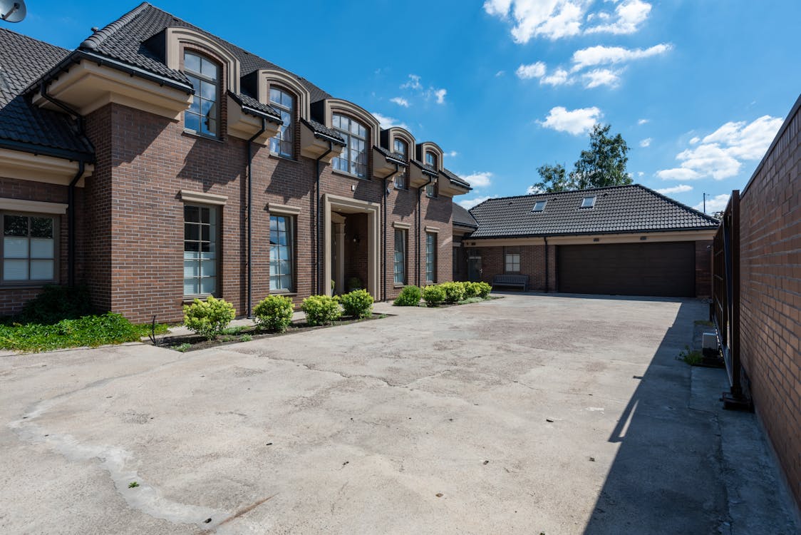 A picture of a brown property under the blue sky