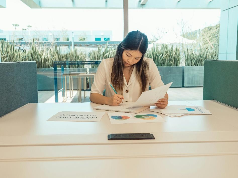 Real estate investor analyzing financial documents and project data in an office setting