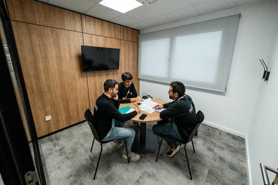 Real estate investors in a conference room discussing investment strategies for manufactured housing