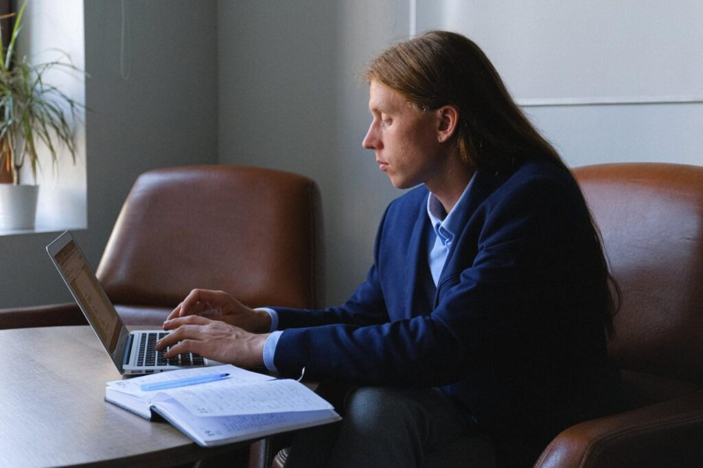 A photo showing a person using a laptop