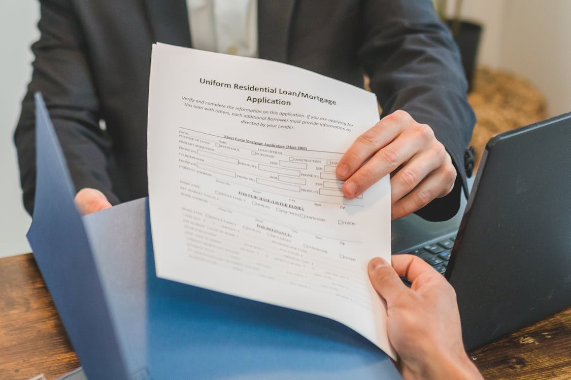 A person handing over a loan agreement