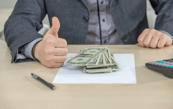 Young businessman counting cash