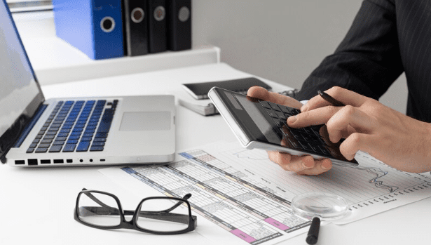 A man using a calculator